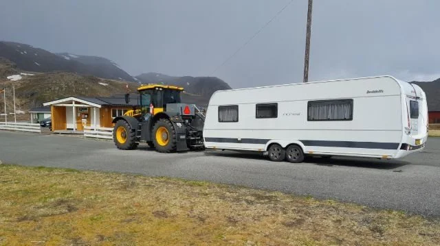 Turen foregik i denne JCB 4220 med campingvognen spændt efter. 
