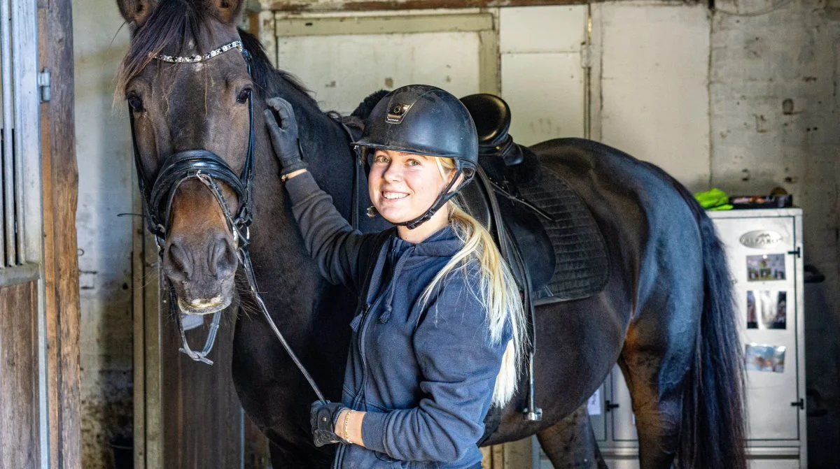 Nikoline Karup arbejder i dag fuldtid på det familieejede Karuplund Ridecenter på Midtsjælland. Hun bruger dagligt timevis i sadlen på nogle af de 45 heste, som er på stedet. 