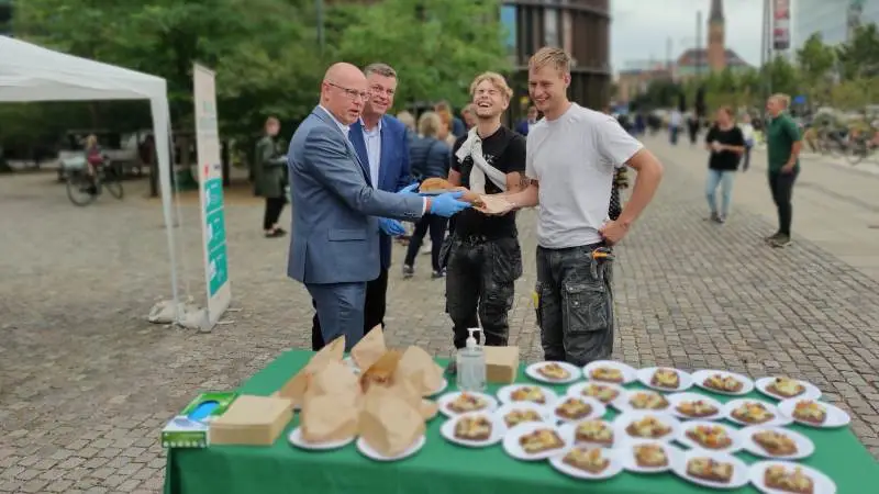 Et par tømrere, der tilfældigt kom forbi, fik fredag ved middagstid en gratis frokost serveret af fødevareminister Mogens Jensen (S) og L&F-direktør Flemming Nør-Pedersen i anledning af en ny kampagne for det statslige dyrevelfærdsmærke. Foto: Lasse Ege Pedersen