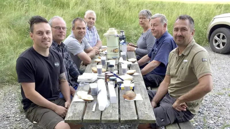 100 års jubilæet blev fejret på Lyngbygård. Fra venstre: Emil Blak, elev, Peter Groth, traktorfører, Morten Bentholm, traktorfører, godsejer Niels Jørgen Bønløkke. Fra højre godsejer Poul Jakob Bønløkke, Anders Peter Eeg, smed og bagerst Irma Bønløkke.