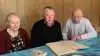 Rita og Flemming Larsen sammen med Barrit Mejeris formand, Bent Pedersen (i midten), der takkede dem for lang og tro tjeneste som leverandører.  Foran dem en gammel familiestambog, hvor man kan finde oplysninger om køerne helt tilbage fra 1945. Fotos: Lene Tingleff, LET Kommunikation