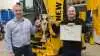 New Holland Construction Danmark har udnævnt Niels Hansen (til højre) som Årets Entreprenørsælger 2021, og det indbragte diplom og vandrepokal, som blev overrakt af Martin Tornøe fra New Holland Construction. Foto: Johs. Mertz A/S