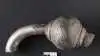 Smykket stammer formentlig fra et plyndringstogt, og de danske vikinger har ikke værdsat smykkets fine kunstneriske detaljer. For dem var det udelukkende sølvsmykkets vægt, der var af betydning. Derfor er ringnålen blev hakket i stykker, og det meste af smykket er formentlig blevet brugt som betalingsmiddel eller omsmeltet til nye smykker i skandinavisk stil.